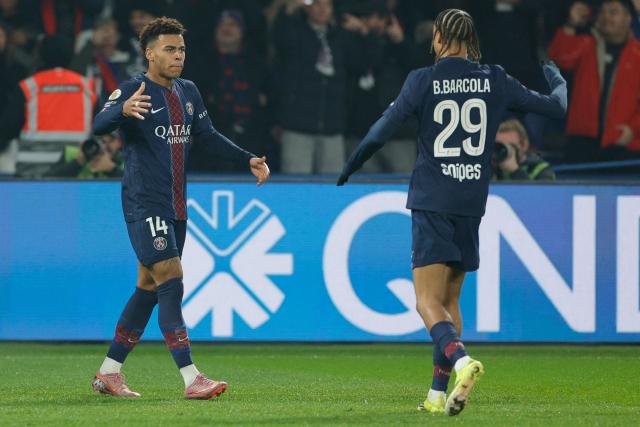 Paris Saint-Germain's French midfielder #14 Desire Doue (L) and Paris Saint-Germain's French forward #29 Bradley Barcola (R) celebrate their team's first goal during the French L1 football match between Paris Saint-Germain (PSG) and Olympique de Marseille (OM) at the Parc des Princes stadium in Paris on February 8, 2026. (Photo by GEOFFROY VAN DER HASSELT / AFP)