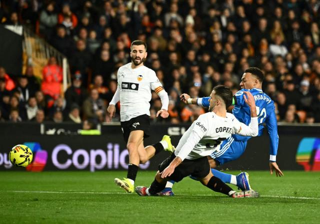 Real Madrid's French forward #10 Kylian Mbappe kicks the ball next to Valencia's Spanish defender # 03 Jose Copete during the Spanish league football match between Valencia CF and Real Madrid CF at Mestalla Stadium in Valencia on February 8, 2026. (Photo by JOSE JORDAN / AFP)