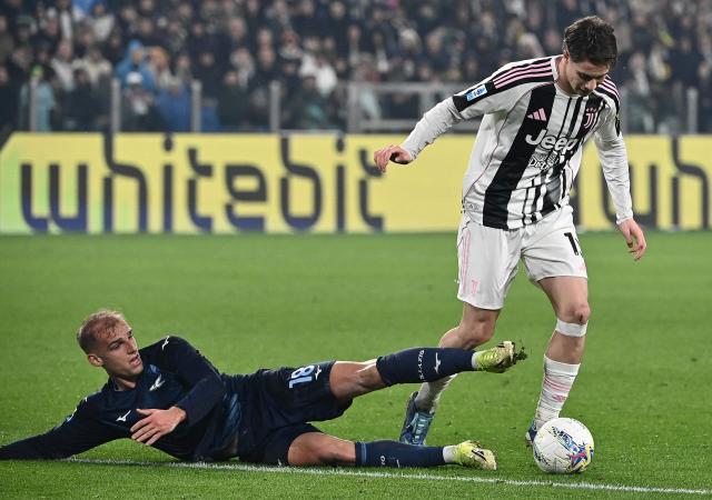 Juventus' Turkish Forward #10 Kenan Yildiz (R) fights for the ball with Lazio's Danish Forward #18 Gustav Isaksen during the Belgian "Pro League" First Division football match between KV Mechelen and Royal Antwerp FC at Achter De Kazerne in Mechelen on February 8, 2026. (Photo by Isabella BONOTTO / BELGA / AFP) / Belgium OUT