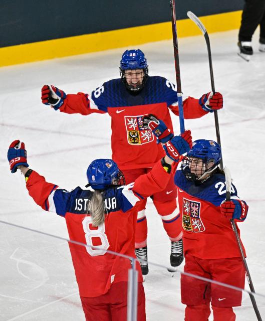 Czech Republic's #08 Tereza Pistekova (L) celebrates with team mates after scoring the first goal during during the women's preliminary round Group A Ice Hockey match between Czech Republic and Finland at the Milano Rho Ice Hockey Arena at the Milano Cortina 2026 Winter Olympic Games in Milan, on February 8, 2026. (Photo by Alexander NEMENOV / AFP)