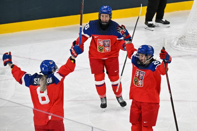 Czech Republic's #08 Tereza Pistekova (L) celebrates with team mates after scoring the first goal during during the women's preliminary round Group A Ice Hockey match between Czech Republic and Finland at the Milano Rho Ice Hockey Arena at the Milano Cortina 2026 Winter Olympic Games in Milan, on February 8, 2026. (Photo by Alexander NEMENOV / AFP)