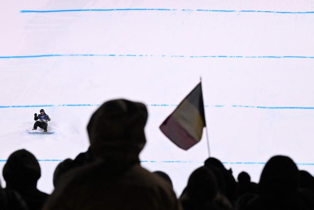 Belgium's Sky Remans competes in the snowboard women's big air qualification run 3 at Livigno Snow Park during the Milano Cortina 2026 Winter Olympic Games, in Livigno (Valtellina), on February 8, 2026. (Photo by Kirill KUDRYAVTSEV / AFP)