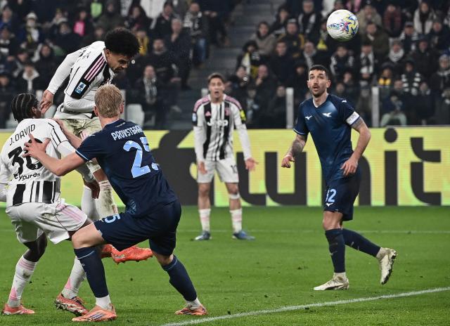 Juventus' US midfielder #22 Weston McKennie (L) heads the ball and scores his team's first goal during the Italian Serie A football match Juventus vs Lazio at the Allianz stadium in Turin on February 8, 2026. (Photo by Isabella BONOTTO / AFP)