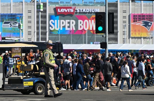 A California Highway Patrol officer keeps an eye on crowds entering Levi's Stadium ahead of Super Bowl LX in Santa Clara, California on February 8, 2026. (Photo by Karl Mondon / AFP)