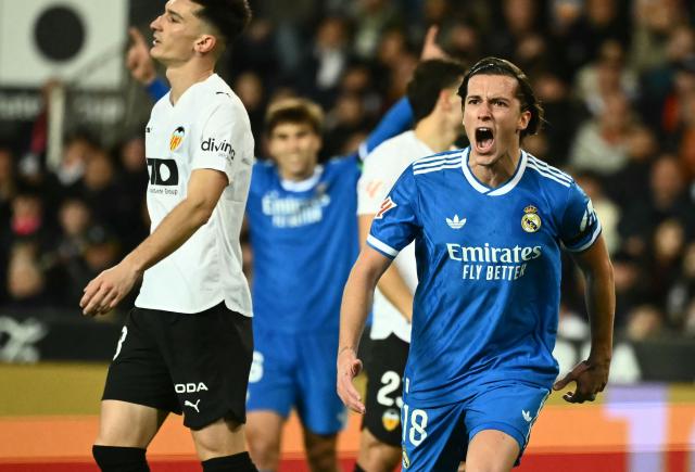 Real Madrid's Spanish defender #18 Alvaro Carreras celebrates scoring his team's first goal during the Spanish league football match between Valencia CF and Real Madrid CF at Mestalla Stadium in Valencia on February 8, 2026. (Photo by JOSE JORDAN / AFP)