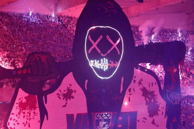 Paris Saint-Germain supporters unvail a giant tifo in the stands during the French L1 football match between Paris Saint-Germain (PSG) and Olympique de Marseille (OM) at the Parc des Princes stadium in Paris on February 8, 2026. (Photo by GEOFFROY VAN DER HASSELT / AFP)