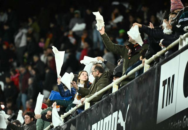 Valencia's supporters wave white handkerchieves at the end of the Spanish league football match between Valencia CF and Real Madrid CF at Mestalla Stadium in Valencia on February 8, 2026. Real Madrid won 0-2. (Photo by JOSE JORDAN / AFP)