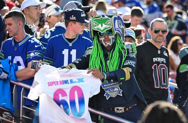 A Seahawks fan waves a shirt ahead of Super Bowl LX between the New England Patriots and the Seattle Seahawks at Levi's Stadium in Santa Clara, California on February 8, 2026. (Photo by JOSH EDELSON / AFP)