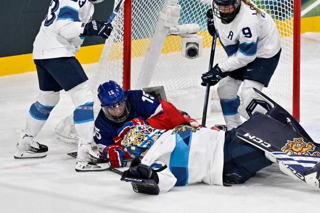 Czech Republic's #15 Andrea Trnkova (3L) interferes on Finland's #36 Anni Keisala for which she receives a penalty during the women's preliminary round Group A Ice Hockey match between Czech Republic and Finland at the Milano Rho Ice Hockey Arena at the Milano Cortina 2026 Winter Olympic Games in Milan, on February 8, 2026. (Photo by Alexander NEMENOV / AFP)
