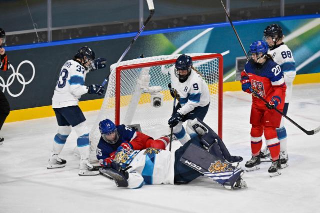Czech Republic's #15 Andrea Trnkova (3L) interferes on Finland's #36 Anni Keisala for which she receives a penalty during the women's preliminary round Group A Ice Hockey match between Czech Republic and Finland at the Milano Rho Ice Hockey Arena at the Milano Cortina 2026 Winter Olympic Games in Milan, on February 8, 2026. (Photo by Alexander NEMENOV / AFP)