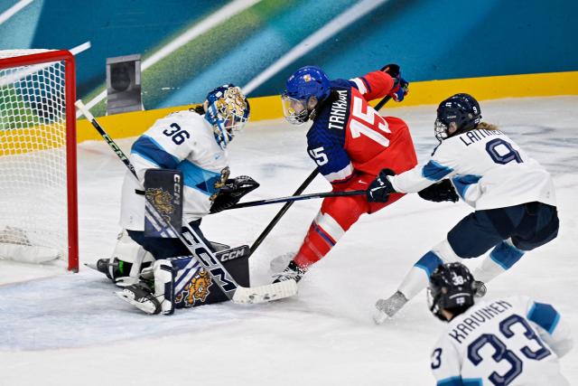 Finland's #36 Anni Keisala (L) and Finland's #09 Nelli Laitinen (R) vies for the puck with Czech Republic's #15 Andrea Trnkova during the women's preliminary round Group A Ice Hockey match between Czech Republic and Finland at the Milano Rho Ice Hockey Arena at the Milano Cortina 2026 Winter Olympic Games in Milan, on February 8, 2026. (Photo by Alexander NEMENOV / AFP)