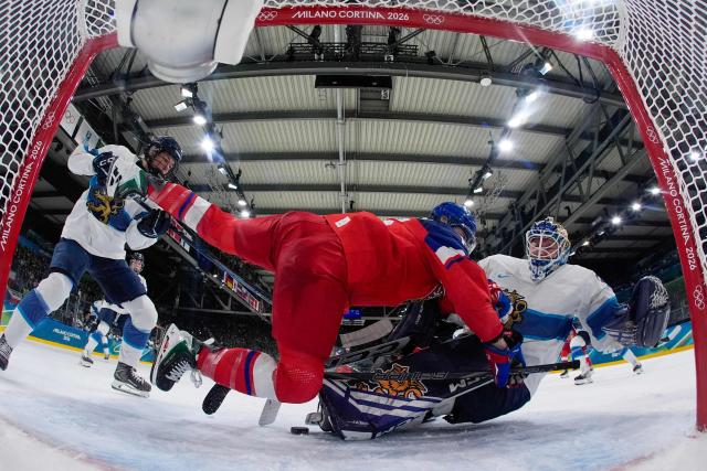 TOPSHOT - Czech Republic's #15 Andrea Trnkova (C) collides with Finland's #36 Anni Keisala (R) during the women's preliminary round Group A Ice Hockey match between Czech Republic and Finland at the Milano Rho Ice Hockey Arena at the Milano Cortina 2026 Winter Olympic Games in Milan, on February 8, 2026. (Photo by Darko Bandic / POOL / AFP)