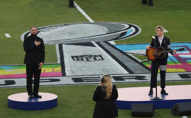 US singer songwriter Brandi Carlile performs America the Beautiful with ALS interpreter Julian Ortiz (L) ahead of Super Bowl LX between the New England Patriots and Seattle Seahawks at Levi’s Stadium in Santa Clara, California on February 8, 2026. (Photo by Patrick T. Fallon / AFP)