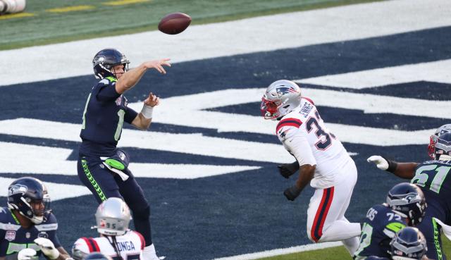 New England Patriots’ linebacker #33 Anfernee Jennings rushes as Seattle Seahawks’ quarterback #14 Sam Darnold throws the football during Super Bowl LX between the New England Patriots and the Seattle Seahawks at Levi's Stadium in Santa Clara, California on February 8, 2026. (Photo by Patrick T. Fallon / AFP)