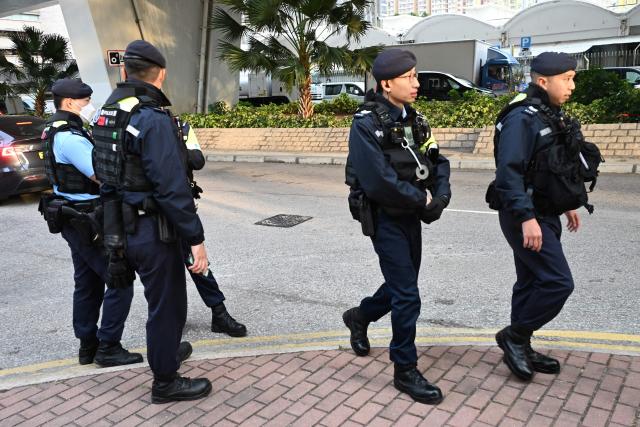 Police keep watch outside the West Kowloon Magistrates' court in Hong Kong on February 9, 2026, for the sentencing of convicted pro-democracy media tycoon Jimmy Lai. Hong Kong pro-democracy media tycoon Jimmy Lai will be sentenced on February 9 over national security crimes that could see him jailed for life, with some rights groups and Western nations still demanding his release. (Photo by Peter PARKS / AFP)