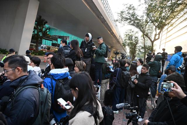 Members of the media wait outside the West Kowloon Magistrates' court in Hong Kong on February 9, 2026, for the sentencing of convicted pro-democracy media tycoon Jimmy Lai. Hong Kong pro-democracy media tycoon Jimmy Lai will be sentenced on February 9 over national security crimes that could see him jailed for life, with some rights groups and Western nations still demanding his release. (Photo by Peter PARKS / AFP)