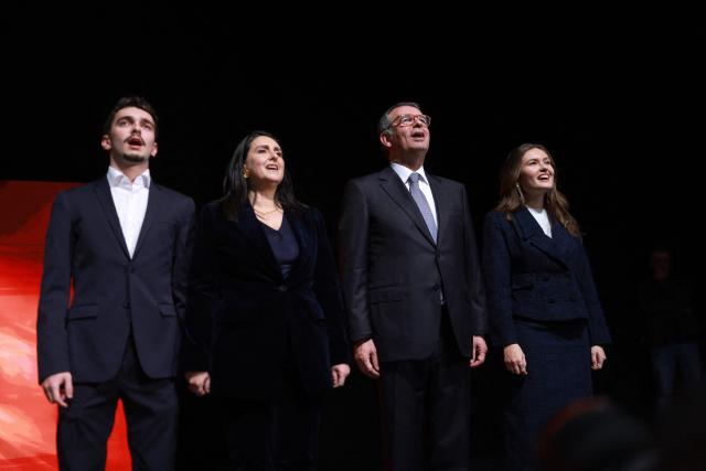 Newly elected Portugal's President socialist Antonio Jose Seguro (2nd-R) sings the national anthem accompanied by his wife Margarida Maldonado Freitas (2nd-L) and their son and daughter after the results of the second-round vote in Lisbon early on February 9, 2026. Centre-left candidate Antonio Jose Seguro's won over a far-right candidate in Portugal's presidential election. (Photo by PATRICIA DE MELO MOREIRA / AFP)
