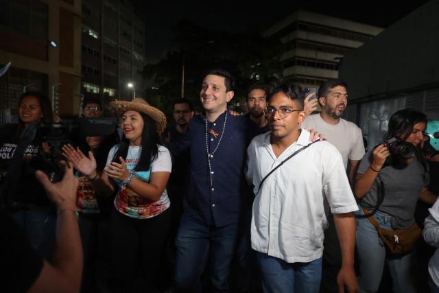 Venezuelan political leaders Jesus Armas (C) walks after his release from Helicoide prison in Caracas on February 8, 2026. Two opposition figures close to Venezuela's Nobel peace laureate Maria Corina Machado were freed from jail on February 8, 2026, one month after authorities began releasing political prisoners following the ouster of leader Nicolas Maduro. (Photo by Pedro MATTEY / AFP)