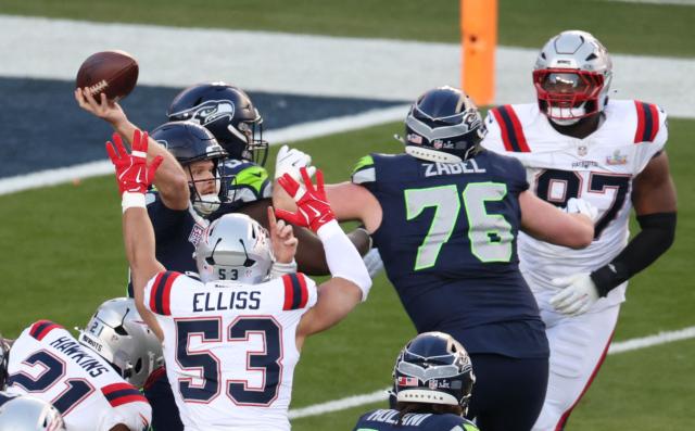 New England Patriots’ linebacker #53 Christian Elliss rushes Seattle Seahawks’ quarterback #14 Sam Darnold as he throws the football during Super Bowl LX between the New England Patriots and the Seattle Seahawks at Levi's Stadium in Santa Clara, California on February 8, 2026. (Photo by Patrick T. Fallon / AFP)