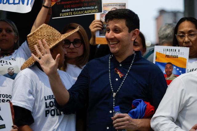 Venezuelan political leader Jesus Armas (R) waves after his release from Helicoide prison in Caracas on February 8, 2026. Two opposition figures close to Venezuela's Nobel peace laureate Maria Corina Machado were freed from jail on February 8, 2026, one month after authorities began releasing political prisoners following the ouster of leader Nicolas Maduro. (Photo by Pedro MATTEY / AFP)