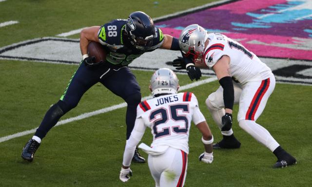 New England Patriots’ cornerback #25 Marcus Jones, New England Patriots’ linebacker #14 Robert Spillane rush Seattle Seahawks’ tight end #88 AJ Barner during Super Bowl LX between the New England Patriots and the Seattle Seahawks at Levi's Stadium in Santa Clara, California on February 8, 2026. (Photo by Patrick T. Fallon / AFP)