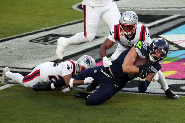 Seattle Seahawks’ tight end #88 AJ Barner is tackled by New England Patriots’ cornerback #25 Marcus Jones (L) and New England Patriots’ safety #31 Craig Woodson during Super Bowl LX between the New England Patriots and the Seattle Seahawks at Levi's Stadium in Santa Clara, California on February 8, 2026. (Photo by Patrick T. Fallon / AFP)