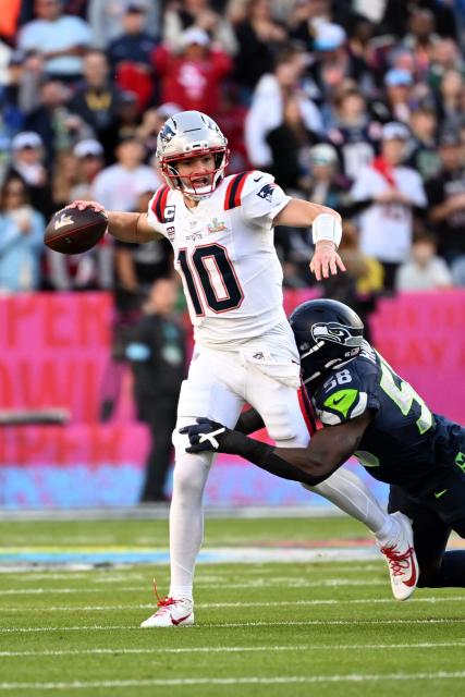 New England Patriots’ quarterback #10 Drake Maye attempts a throw as he's tackled by Seattle Seahawks’ linebacker #58 Derick Hall during Super Bowl LX between the New England Patriots and the Seattle Seahawks at Levi's Stadium in Santa Clara, California on February 8, 2026. (Photo by JOSH EDELSON / AFP)