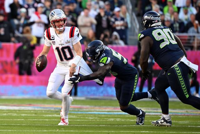 Seattle Seahawks’ linebacker #58 Derick Hall (C) pulls the undershirt of New England Patriots’ quarterback #10 Drake Maye during Super Bowl LX between the New England Patriots and the Seattle Seahawks at Levi's Stadium in Santa Clara, California on February 8, 2026. (Photo by JOSH EDELSON / AFP)