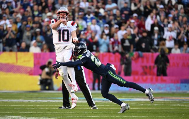 Seattle Seahawks’ cornerback #21 Devon Witherspoon taclkes New England Patriots’ quarterback #10 Drake Maye after he throws the football during Super Bowl LX between the New England Patriots and the Seattle Seahawks at Levi's Stadium in Santa Clara, California on February 8, 2026. (Photo by JOSH EDELSON / AFP)