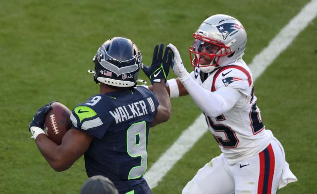 New England Patriots’ cornerback #25 Marcus Jones attempts to tackle Seattle Seahawks’ running back #09 Kenneth Walker III during Super Bowl LX between the New England Patriots and the Seattle Seahawks at Levi's Stadium in Santa Clara, California on February 8, 2026. (Photo by Patrick T. Fallon / AFP)