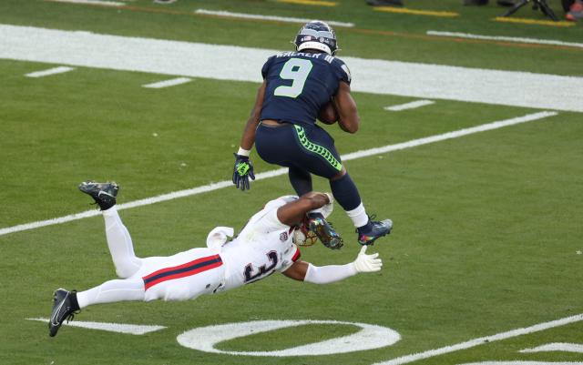 New England Patriots’ safety #31 Craig Woodson tackles Seattle Seahawks’ running back #09 Kenneth Walker III during Super Bowl LX between the New England Patriots and the Seattle Seahawks at Levi's Stadium in Santa Clara, California on February 8, 2026. (Photo by Patrick T. Fallon / AFP)
