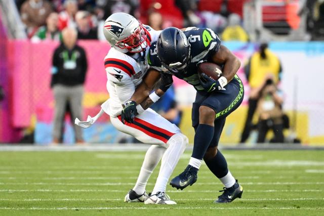 Seattle Seahawks’ running back #09 Kenneth Walker III wrestles New England Patriots’ cornerback #07 Carlton Davis III during Super Bowl LX between the New England Patriots and the Seattle Seahawks at Levi's Stadium in Santa Clara, California on February 8, 2026. (Photo by JOSH EDELSON / AFP)