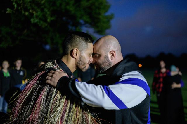 (FILES) A Muslim man (R) and another local perform a traditional Maori 'hongi' greeting, a touching of noses, after Muslims prayed in front of the Al Noor mosque while being protected by locals, following a mass haka in Christchurch on March 20, 2019, five days after the twin mosque shootings claimed the lives of 50 people. A white supremacist who shot and killed 51 people at two New Zealand mosques in 2019 launched an appeal on February 9, 2026 seeking to overturn his conviction. Brenton Tarrant, an Australian former gym instructor, admitted carrying out New Zealand's deadliest modern-day mass shooting before being sentenced to life in jail in August 2020. (Photo by Anthony WALLACE / AFP)