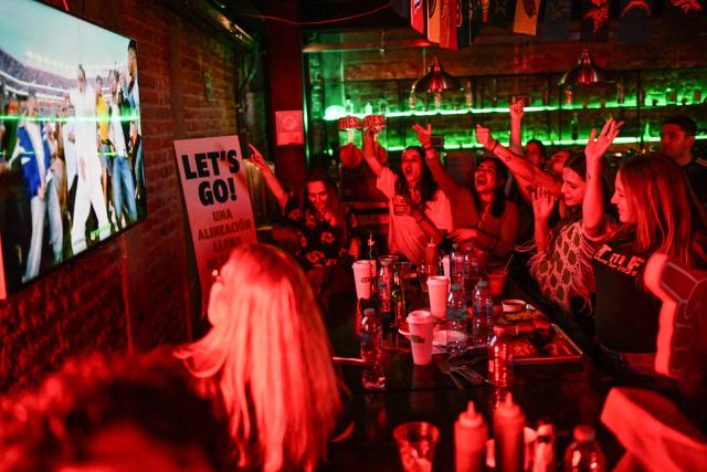People watch the Puerto Rican singer Bad Bunny's halftime show during the Super Bowl LX between the New England Patriots and the Seattle Seahawks at a restaurant in Mexico City on February 8, 2026. (Photo by Yuri CORTEZ / AFP)