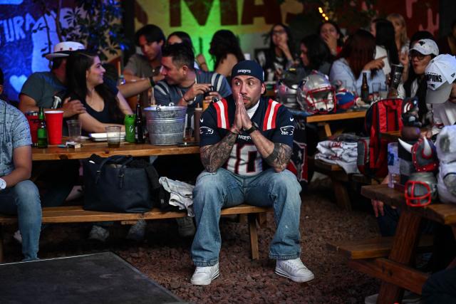 A supporter of the New England Patriots watches the Super Bowl LX between the New England Patriots and the Seattle Seahawks at a restaurant in Mexico City on February 8, 2026. (Photo by Yuri CORTEZ / AFP)