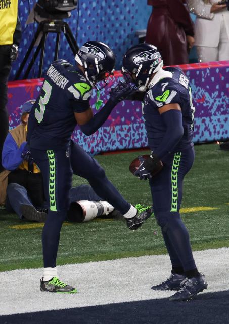 Seattle Seahawks’ safety #03 Nick Emmanwori and Seattle Seahawks’ linebacker #07 Uchenna Nwosu celebrate Nosu's touchdown during Super Bowl LX between the New England Patriots and the Seattle Seahawks at Levi's Stadium in Santa Clara, California on February 8, 2026. (Photo by Patrick T. Fallon / AFP)