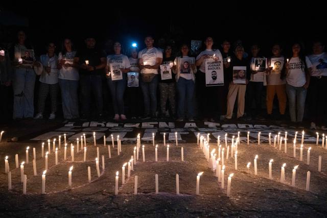People light candles during a vigil to demand the release of political prisoners outside El Rodeo I prison in Guatire, Miranda state, Venezuela on February 8, 2026. Two opposition figures close to Venezuela's Nobel peace laureate Maria Corina Machado were freed from jail on February 8, 2026, one month after authorities began releasing political prisoners following the ouster of leader Nicolas Maduro. (Photo by Maryorin Mendez / AFP)