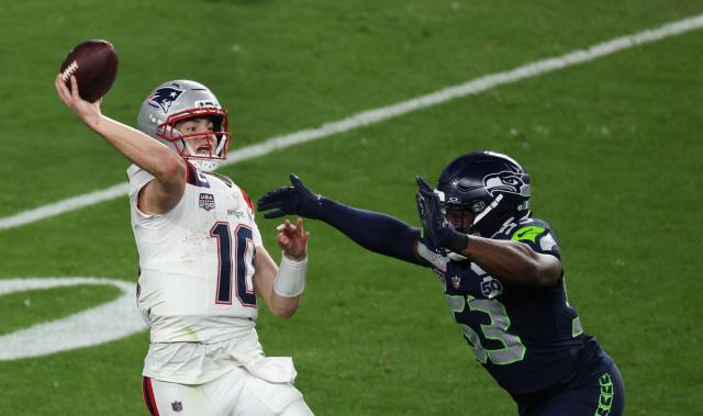 Seattle Seahawks’ linebacker #53 Boye Mafe attempts to block New England Patriots’ quarterback #10 Drake Maye during Super Bowl LX between the New England Patriots and the Seattle Seahawks at Levi's Stadium in Santa Clara, California on February 8, 2026. (Photo by Patrick T. Fallon / AFP)