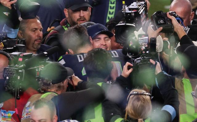 Seattle Seahawks quarterback #14 Sam Darnold hugs head coach Mike Macdonald after the Seahawks’ victory over the New England Patriots during Super Bowl LX at Levi’s Stadium in Santa Clara, California, on February 8, 2026. (Photo by Patrick T. Fallon / AFP)