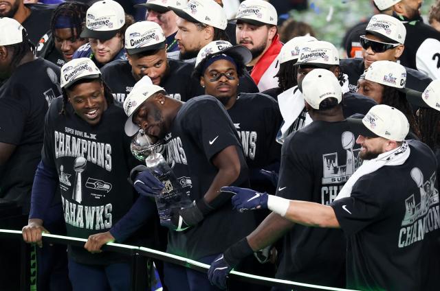 Seattle Seahawks' players celebrate with the Vince Lombardi Trophy after defeating the New England Patriots during Super Bowl LX at Levi's Stadium in Santa Clara, California on February 8, 2026. (Photo by Patrick T. Fallon / AFP)