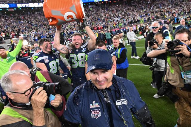 Seattle Seahawks' head coach Mike Macdonald is drenched after Seattle Seahawks’ fullback #38 Brady Russell poured gatorade on him after the Seattle Seahawks defeated the New England Patriots during Super Bowl LX at Levi's Stadium in Santa Clara, California on February 8, 2026. (Photo by JOSH EDELSON / AFP)