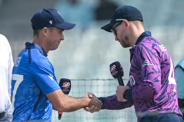 Italy's captain Wayne Madsen (L) shakes hands with his Scotland counterpart Richie Berrington during coin toss before the start of the 2026 ICC Men's T20 Cricket World Cup group stage match between Scotland and Italy at the Eden Gardens in Kolkata on February 9, 2026. (Photo by Dibyangshu SARKAR / AFP)