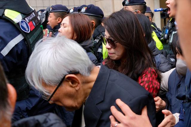 Teresa Lai (centre R), wife of convicted pro-democracy media tycoon Jimmy Lai and Joseph Zen (front), retired cardinal of the Catholic Church, leave the West Kowloon Magistrates Court following Jimmy Lai's sentencing in Hong Kong on February 9, 2026. A Hong Kong court on February 9 sentenced pro-democracy media mogul Jimmy Lai to 20 years in prison following his high-profile national security trial that rights groups and Western nations have condemned as a symbol of the city's shrivelling press freedoms. (Photo by Tommy WANG / AFP)
