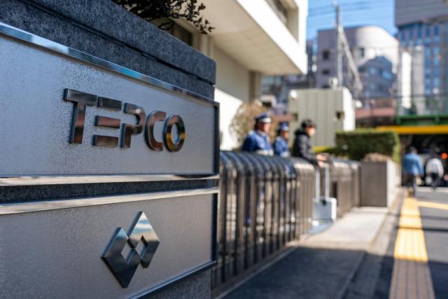 The logo of Tokyo Electric Power Company is seen at an entrance to the company's headquarters in Tokyo on February 9, 2026. Japan switched on the world's biggest nuclear power plant again February 9, its operator said, after an earlier attempt was quickly suspended due to a minor glitch. (Photo by Kazuhiro NOGI / AFP)