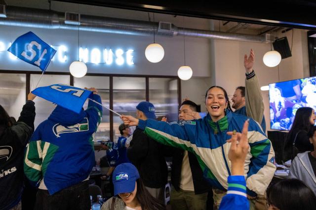 Seattle Seahawks fans celebrate in Pioneer Square after the Seahawks defeated the New England Patriots to win Super Bowl LX, in Seattle, Washington, on February 8, 2026. (Photo by Jason Redmond / AFP)