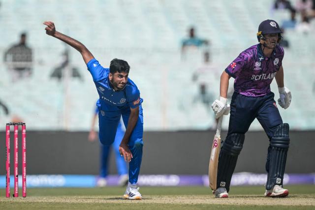 Italy's Ali Hasan (L) delivers a ball as Scotland's Brandon McMullen looks on during the 2026 ICC Men's T20 Cricket World Cup group stage match between Scotland and Italy at the Eden Gardens in Kolkata on February 9, 2026. (Photo by Dibyangshu SARKAR / AFP)