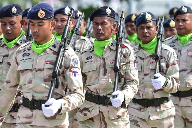 Thai civilian defence volunteers take part in a parade on the eve of the annual Defence Volunteers Day in Narathiwat, southern Thailand on February 9, 2026. (Photo by Madaree TOHLALA / AFP)