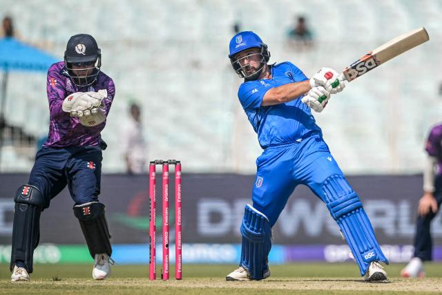 Italy's Anthony Mosca (R) plays a shot as Scotland's wicketkeeper Matthew Cross fields during the 2026 ICC Men's T20 Cricket World Cup group stage match between Scotland and Italy at the Eden Gardens in Kolkata on February 9, 2026. (Photo by Dibyangshu SARKAR / AFP)