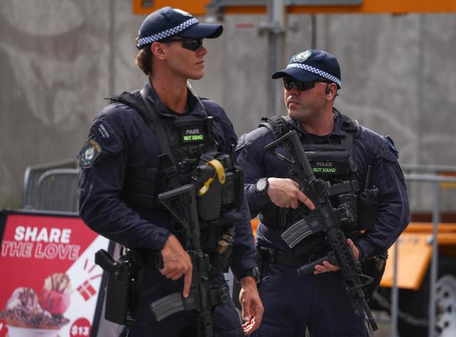 Police officers stand guard ahead of an event titled 'An Evening of Light & Solidarity' for the victims of the December 14, 2025 gun attack in Sydney on February 9, 2026. Herzog said February 9 people of all faiths will "overcome this evil" as he paid respect to victims of a shooting that killed 15 people celebrating a Jewish festival on Sydney's Bondi Beach. (Photo by David GRAY / AFP)