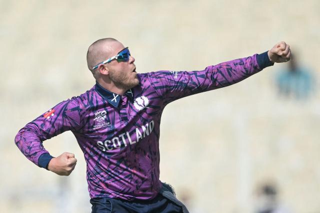 Scotland's Michael Leask celebrates after taking the wicket of Italy's Grant Stewart during the 2026 ICC Men's T20 Cricket World Cup group stage match between Scotland and Italy at the Eden Gardens in Kolkata on February 9, 2026. (Photo by Dibyangshu SARKAR / AFP)